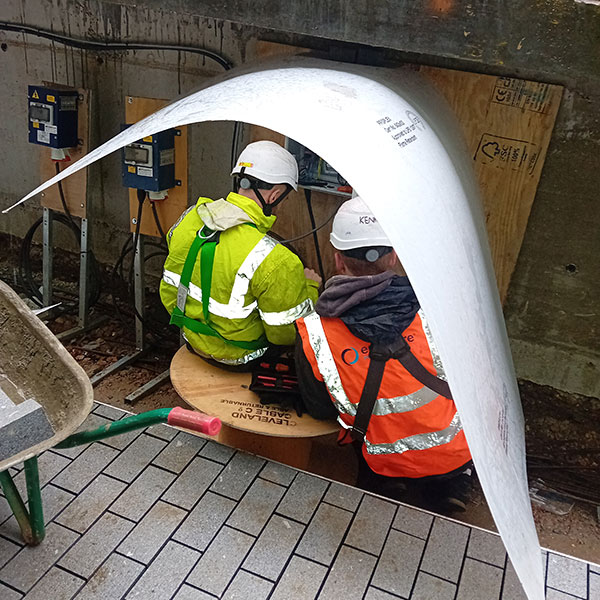 Our ever resourceful engineers installing the control panel in the rain.